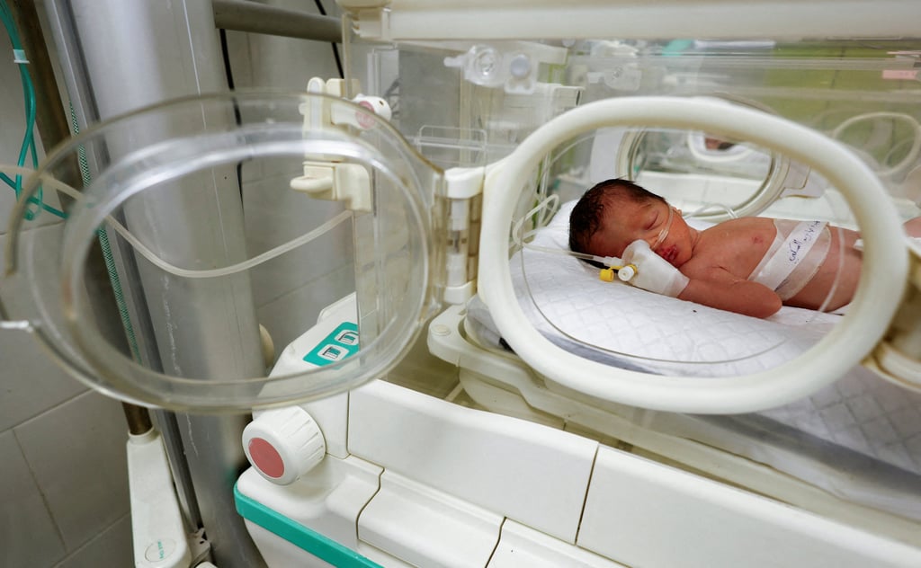 A Palestinian baby girl, saved from the womb of her mother, who was killed in an Israeli strike along with her husband and daughter, lies in an incubator at a hospital in Rafah in the southern Gaza Strip on Sunday. Photo: Reuters