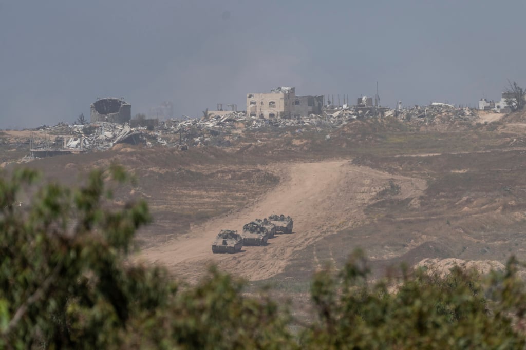 Israeli armoured personnel carriers move near the Israeli-Gaza border last Wednesday. Photo; AP