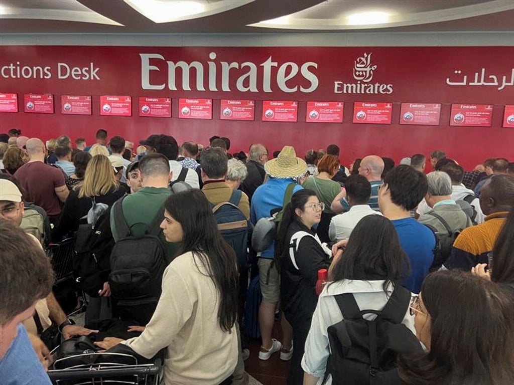 Passengers queued for hours at flight connection desks at Dubai International Airport after record-breaking rain hit the United Arab Emirates, causing widespread flooding. Photo: Reuters