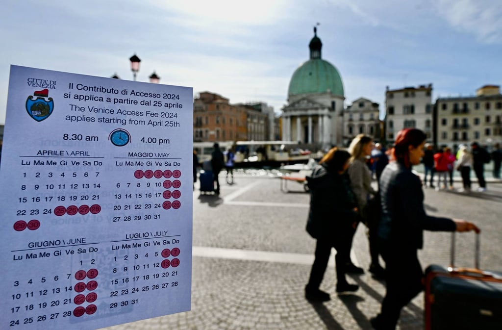 A calendar showing the busy days on which Venice will charge day trippers to enter its historic centre between now and July is displayed in front of its Santa Lucia railway station. Photo: AFP