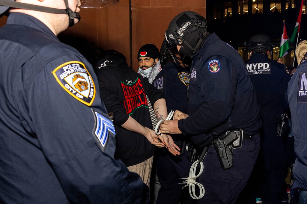 NYPD officers detaining pro-Palestinian students and protesters on the campus of New York University on Monday. Photo: TNS NYPD officers detaining pro-Palestinian students and protesters on the campus of New York University on Monday. Photo: TNS