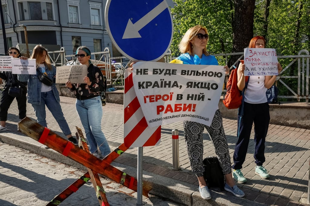 Relatives of Ukrainian servicemen hold placards in Kyiv on April 11 as they attend a rally to demand that lawmakers add terms of demobilisation to new bill. Photo: Reuters