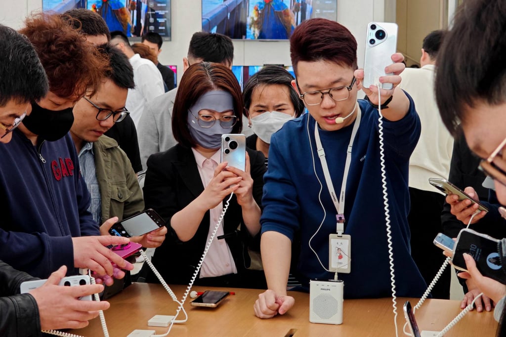 People try out Huawei’s Pura 70 series smartphones at a store in Shanghai. Photo: AFP People try out Huawei’s Pura 70 series smartphones at a store in Shanghai. Photo: AFP