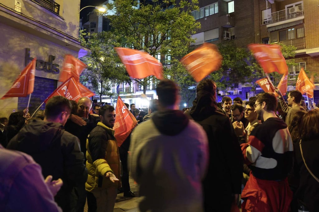 Supporters waving flags as they gather in front of the headquarters of PSOE, Spain’s Socialist party, in Madrid on Wednesday. Photo: AFP Supporters waving flags as they gather in front of the headquarters of PSOE, Spain’s Socialist party, in Madrid on Wednesday. Photo: AFP