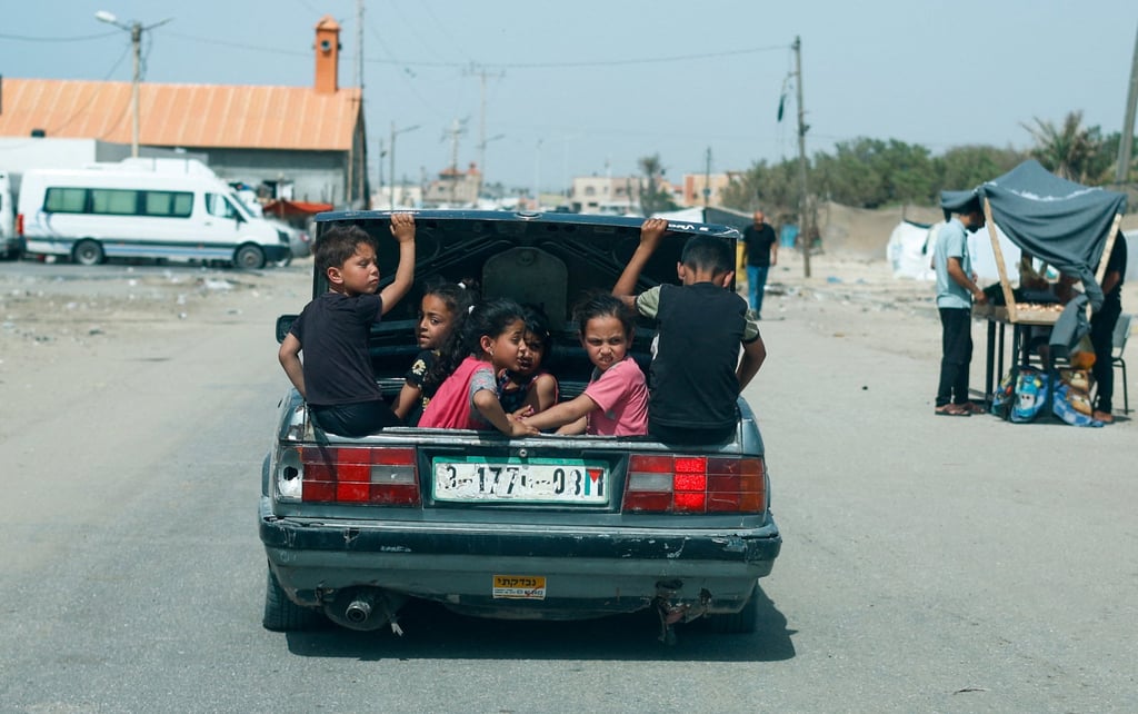 Children sit in a car boot in Rafah, in the southern Gaza Strip, on Wednesday. Photo: Reuters