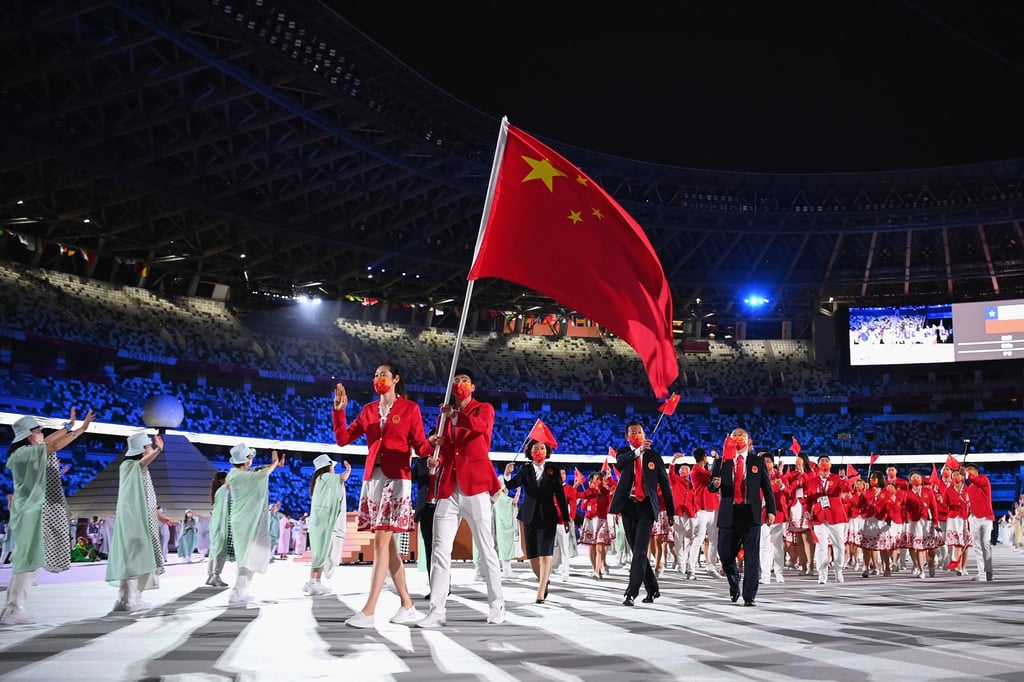 Chinese flag bearers Ting Zhu and Shuai Zhao lead their team out during the opening ceremony for the Tokyo Olympics. Photo: Getty Images Chinese flag bearers Ting Zhu and Shuai Zhao lead their team out during the opening ceremony for the Tokyo Olympics. Photo: Getty Images