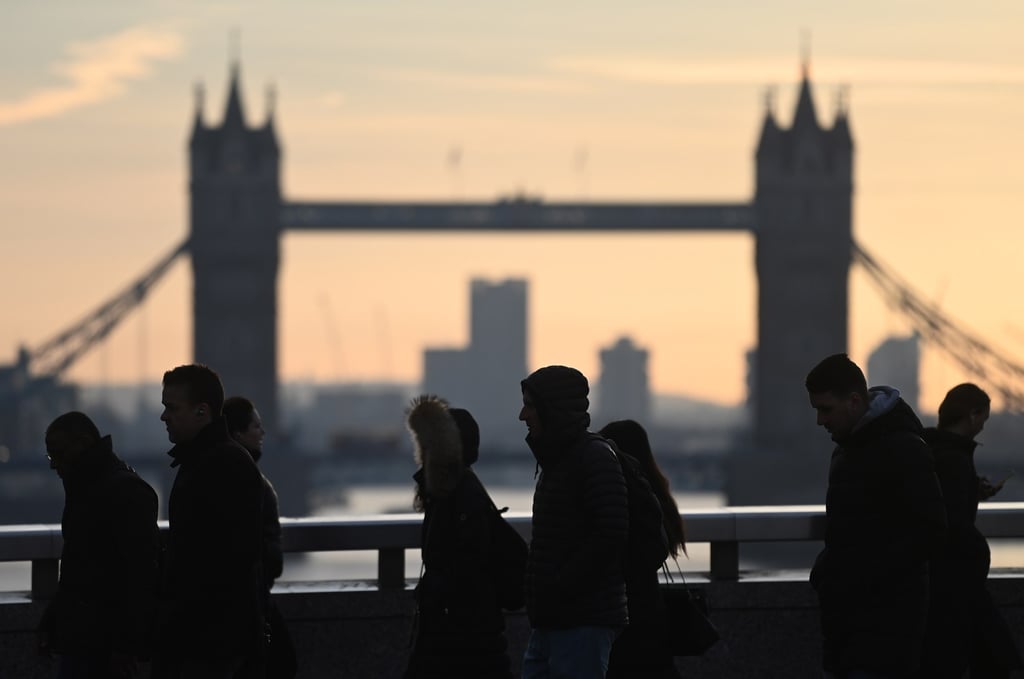 Commuters pass Tower Bridge in London. A 20-year-old British man has been charged with masterminding an arson plot against a Ukrainian-linked target in London for the benefit of the Russian state. Photo: EPA-EFE