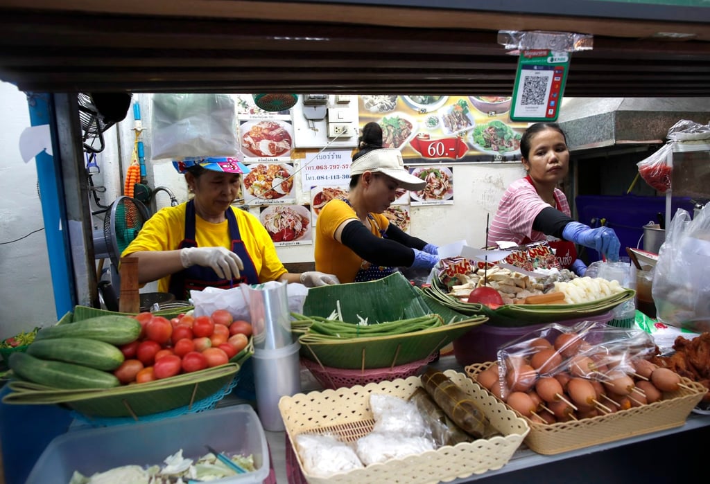 Street vendors prepare food for sale in Bangkok. The Thai government is optimistic about the impact of its proposed “digital wallet” spending stimulus on domestic consumption. Photo: EPA-EFE