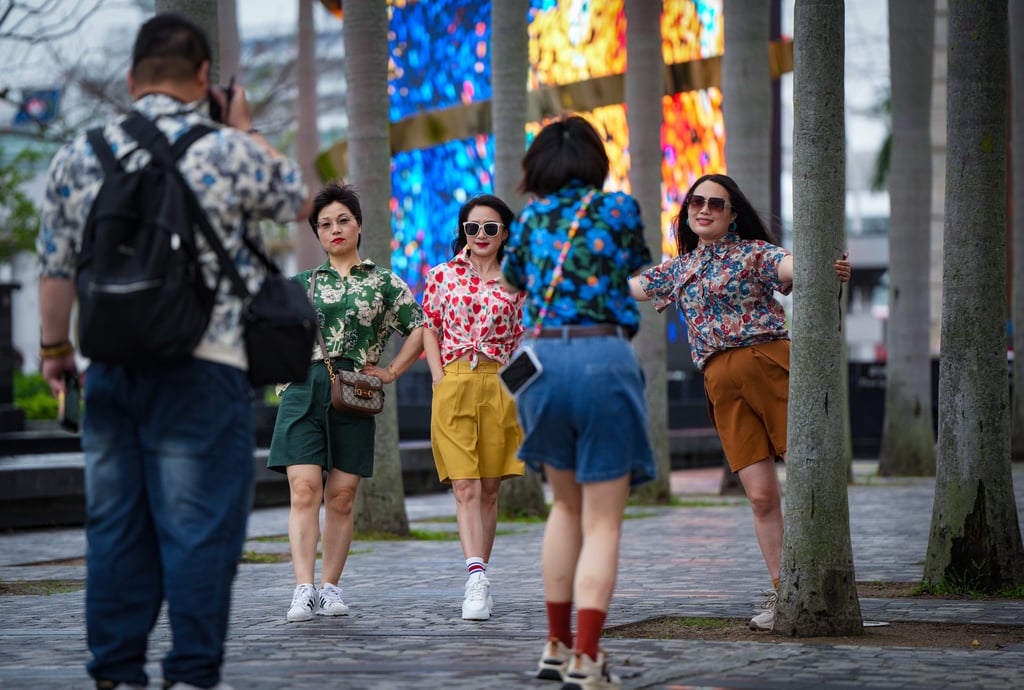 Tourists from mainland China take pictures in Hong Kong. Photo: Sam Tsang Tourists from mainland China take pictures in Hong Kong. Photo: Sam Tsang