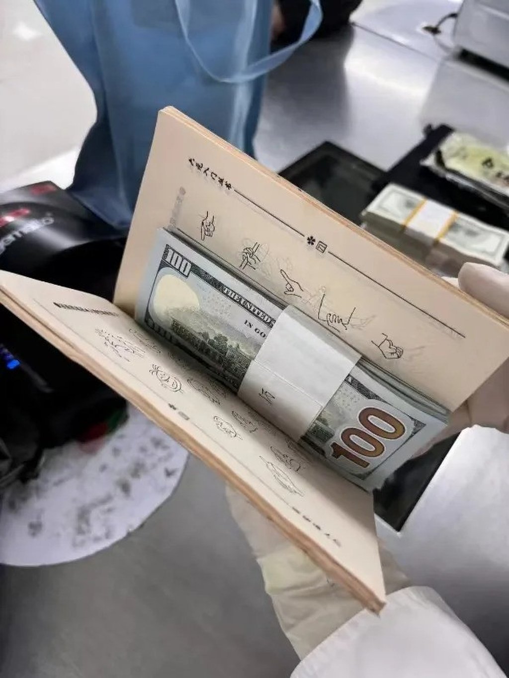 The US$100 bills were also hidden in books. Photo: SCMP The US$100 bills were also hidden in books. Photo: SCMP