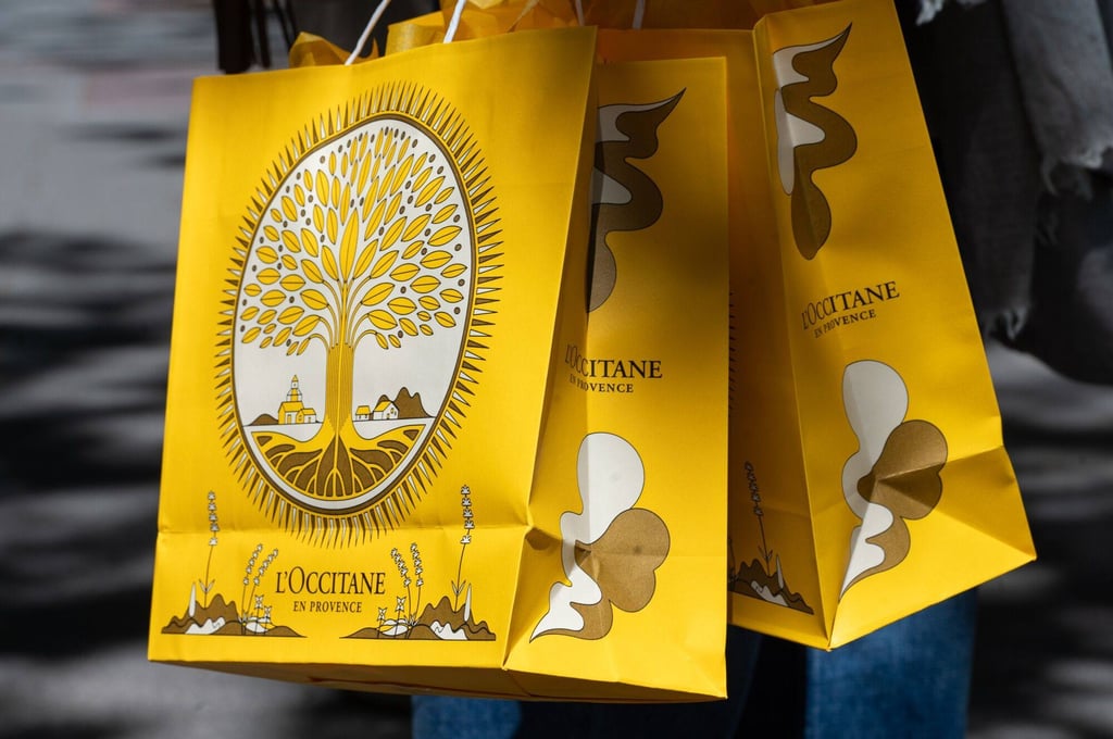 A shopper carries bags from L’Occitane International in Madrid, Spain, on April 9, 2024. Photo: Bloomberg