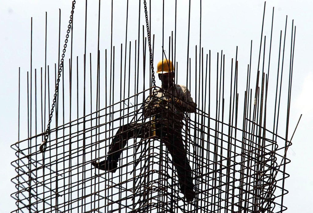 A worker secures a metal frame at a construction site in Singapore. The dip was largely driven by a slump in construction jobs. Photo: AFP A worker secures a metal frame at a construction site in Singapore. The dip was largely driven by a slump in construction jobs. Photo: AFP