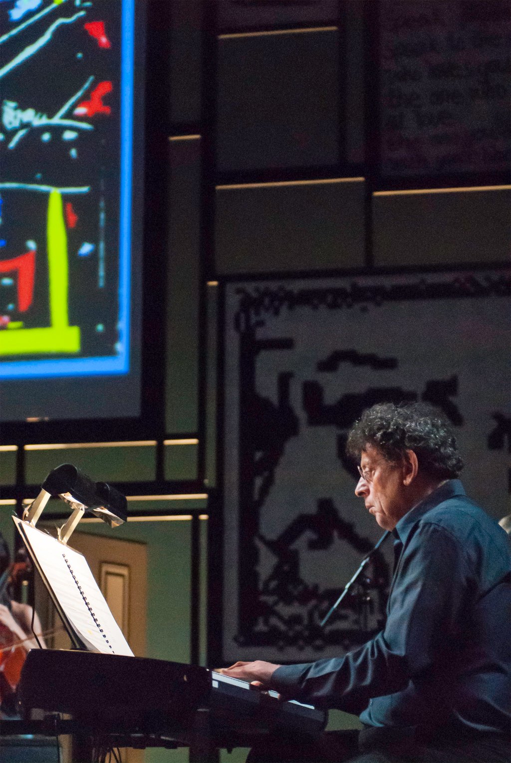 Philip Glass leads an ensemble of musicians in Book of Longing, a collaboration with poet and songwriter Leonard Cohen, in New York in 2007. Photo: Getty Images Philip Glass leads an ensemble of musicians in Book of Longing, a collaboration with poet and songwriter Leonard Cohen, in New York in 2007. Photo: Getty Images