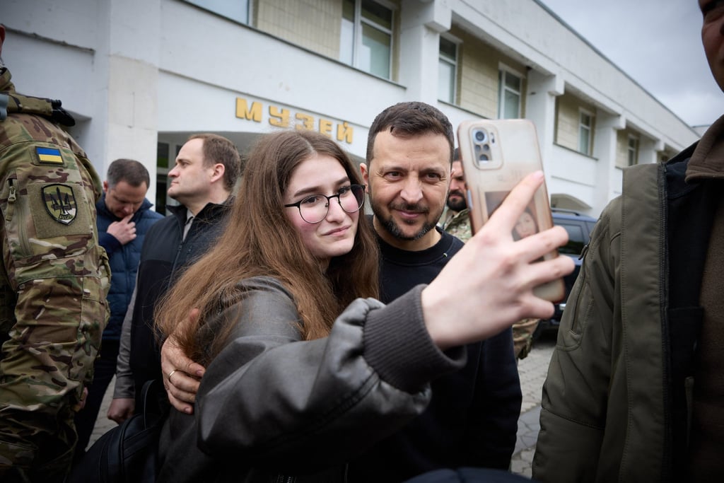 Ukrainian President Volodymyr Zelensky has a selfie taken with a resident in Slavutych, the city where Chernobyl plant personnel lived some 50km from the accident site, in April. Photo: Ukrainian presidential press service via AFP