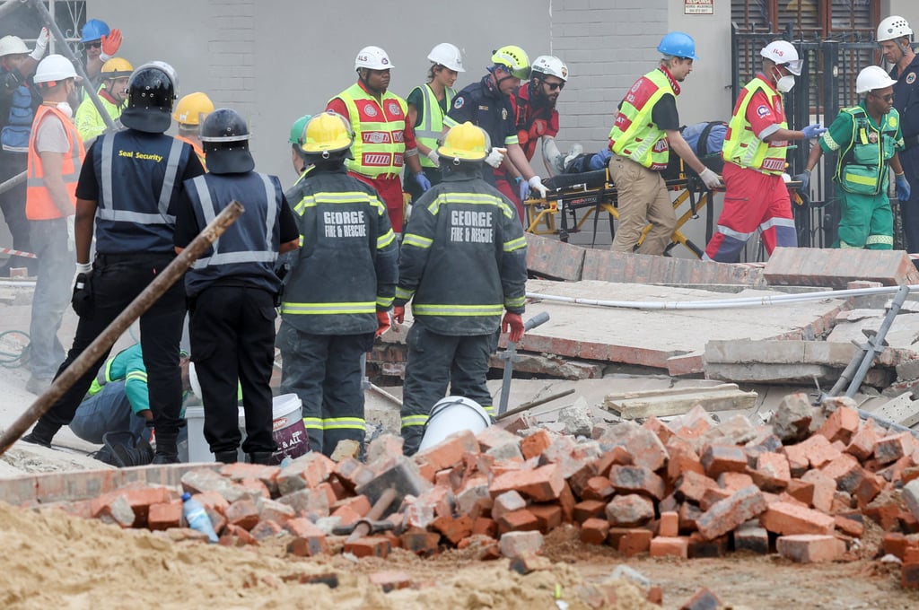 Rescuers work to rescue construction workers trapped under a building that collapsed in George, South Africa. Photo: Reuters