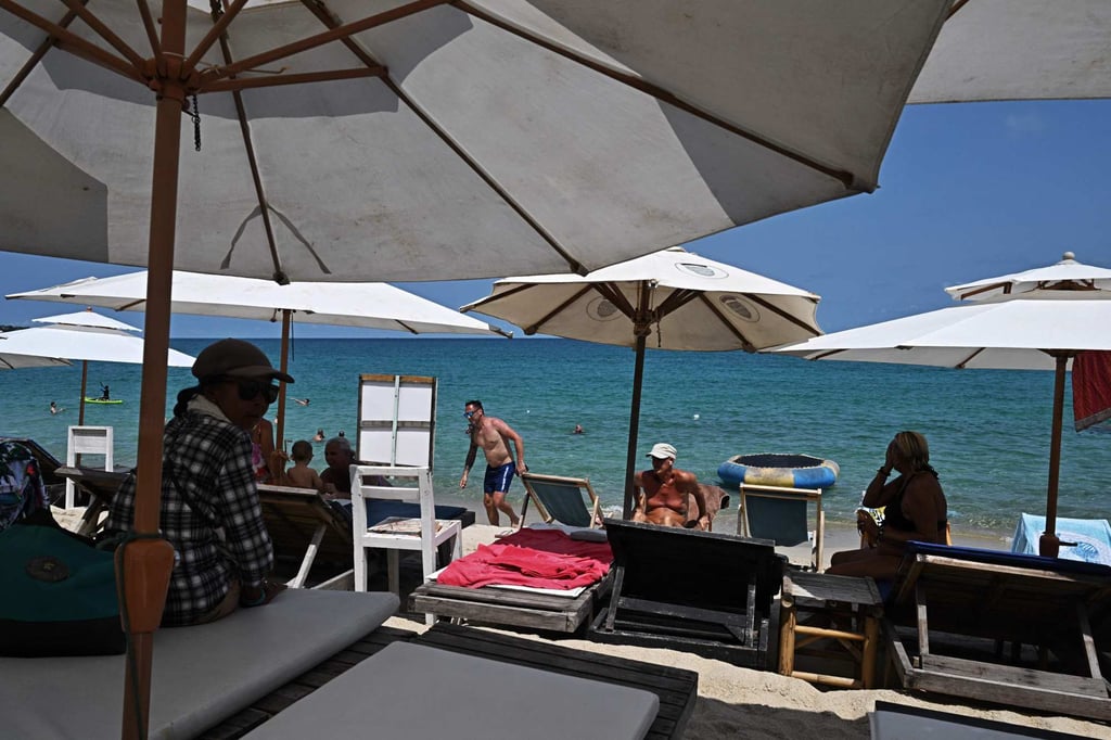 People relax on Lamai beach on Thailand’s Koh Samui island on April 9. Under Thai law, foreigners are not allowed to own more than 49 per cent of real estate in the country. Photo: AFP People relax on Lamai beach on Thailand’s Koh Samui island on April 9. Under Thai law, foreigners are not allowed to own more than 49 per cent of real estate in the country. Photo: AFP