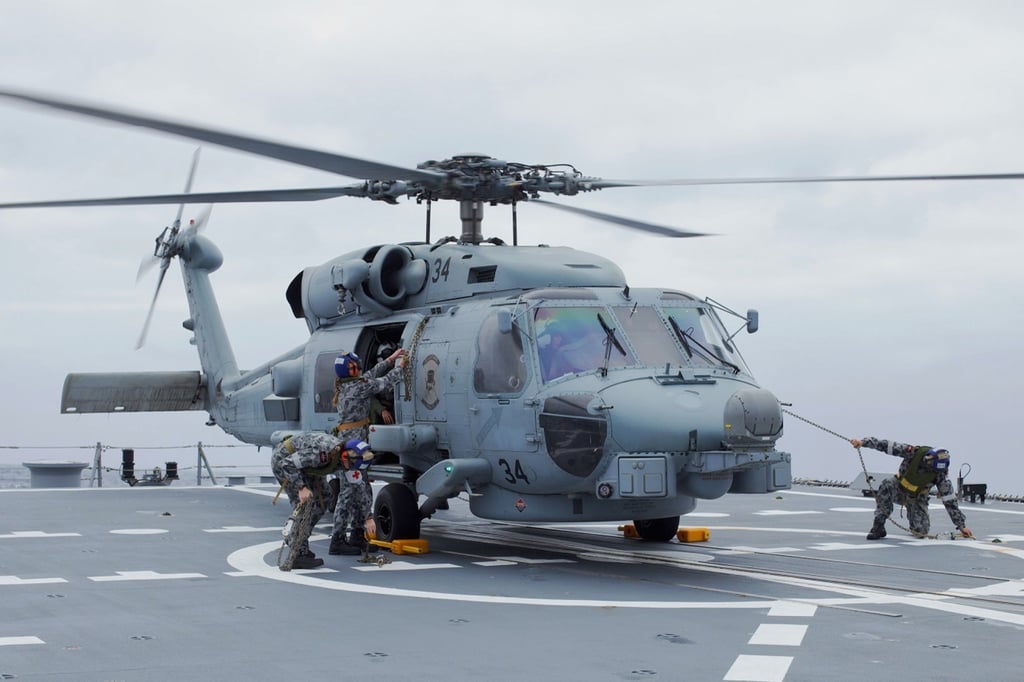 A Seahawk helicopter prepares to launch from the Australian destroyer HMAS Sydney on March 31. Photo: HMAS Sydney