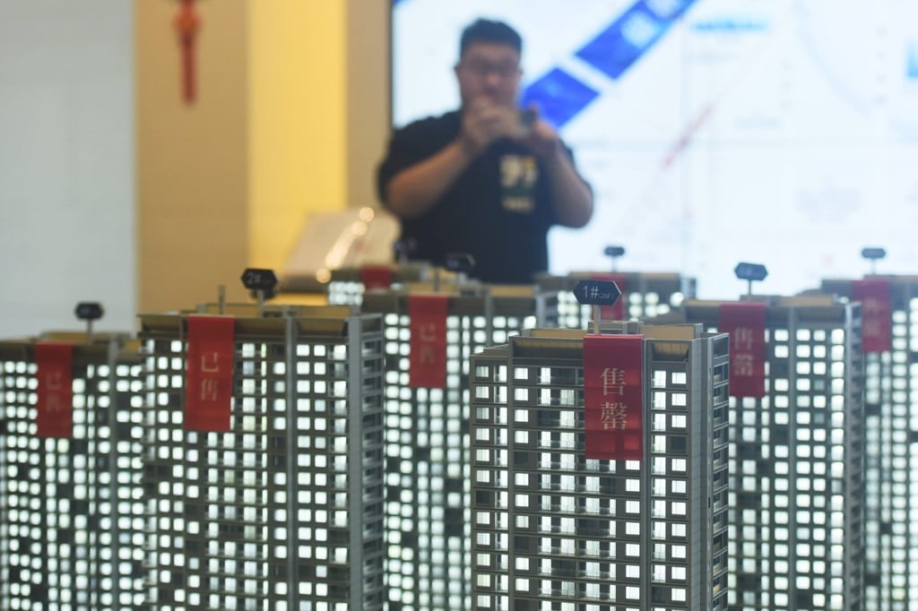 A customer is looking at a model of a property at a real estate sales centre in Hangzhou, Zhejiang Province, China, on January 17, 2024. Photo: Getty Images A customer is looking at a model of a property at a real estate sales centre in Hangzhou, Zhejiang Province, China, on January 17, 2024. Photo: Getty Images