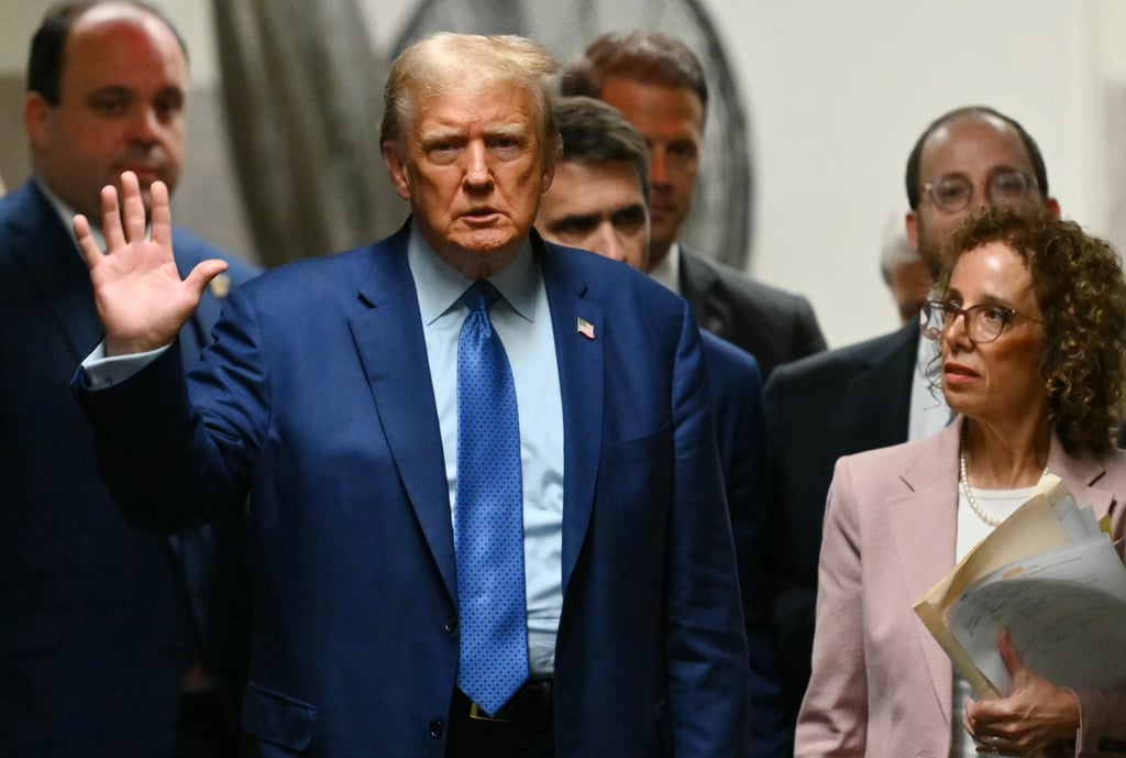 Former US president Donald Trump waves next to his lawyer Susan Necheles as he returns after a break in his hush money trial in New York on Thursday. Photo: EPA-EFE