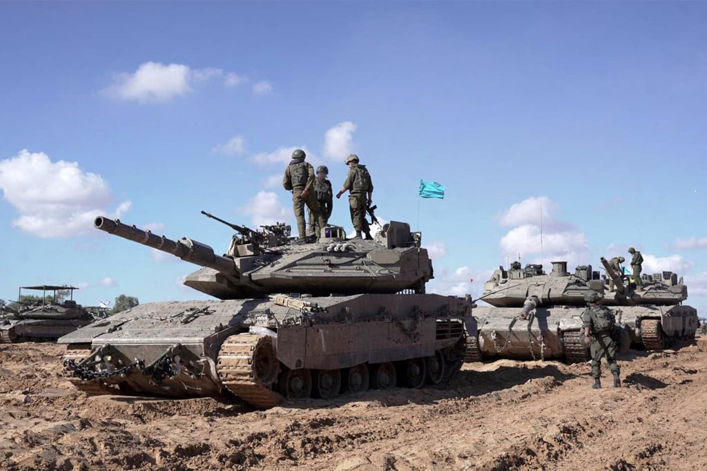 Israeli soldiers stand atop a main battle tank in eastern Rafah in a photo released on Friday. Photo: Israeli Army via AFP