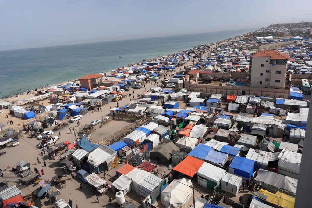 Tents housing internally displaced Palestinians crowd the shoreline in Deir el-Balah in the central Gaza Strip on Friday. Photo: AFP