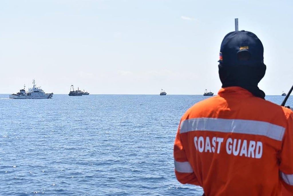 Philippine coastguard personnel monitoring Chinese vessels (right) at Sabina Shoal in the South China Sea in 2021. Photo: Handout / Philippine Coast Guard / AFP