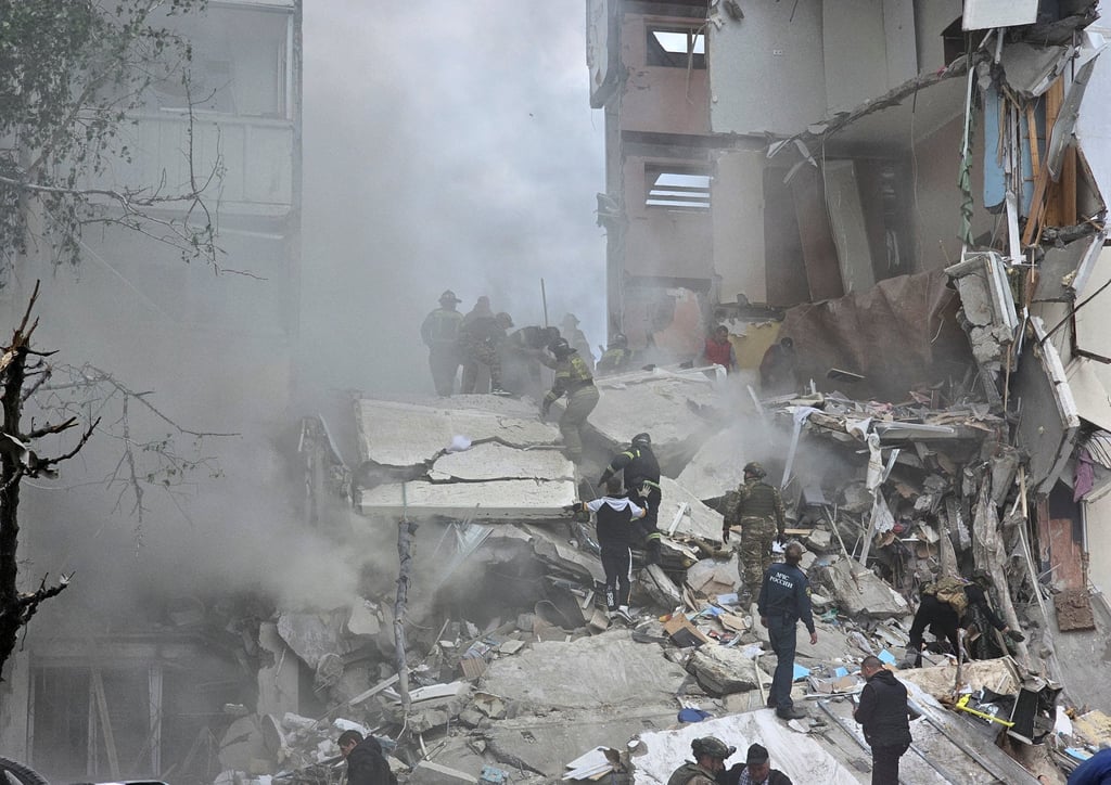 Debris is removed following the collapse of a section of a multi-storey block of flats as the result of what local authorities called a Ukrainian missile strike in the Russian city of Belgorod. Photo: Reuters