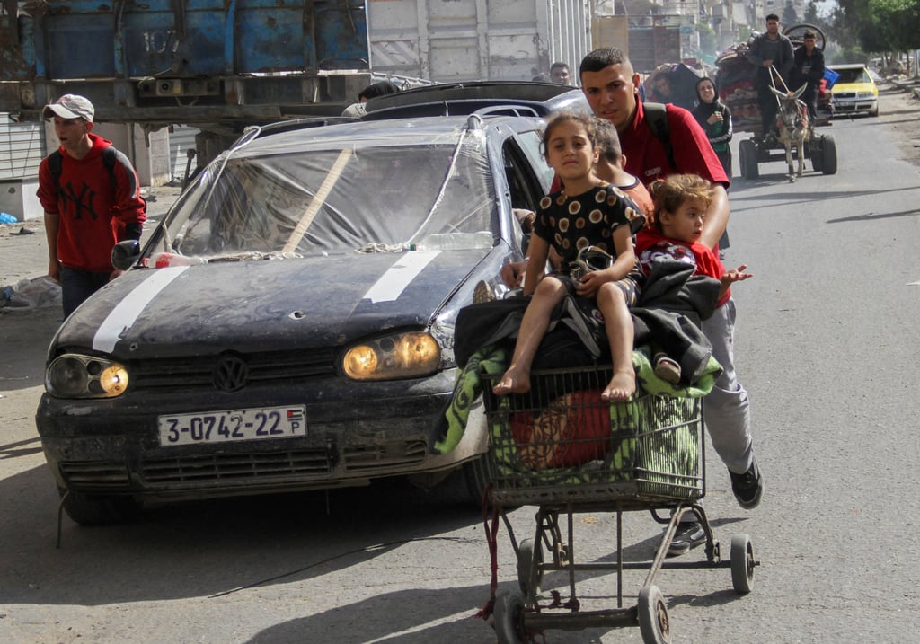 A displaced Palestinian man, who fled Jabilia after the Israeli military called on residents to evacuate, pushes children in a trolley as they make their way towards Gaza City on Sunday. Photo: Reuters A displaced Palestinian man, who fled Jabilia after the Israeli military called on residents to evacuate, pushes children in a trolley as they make their way towards Gaza City on Sunday. Photo: Reuters