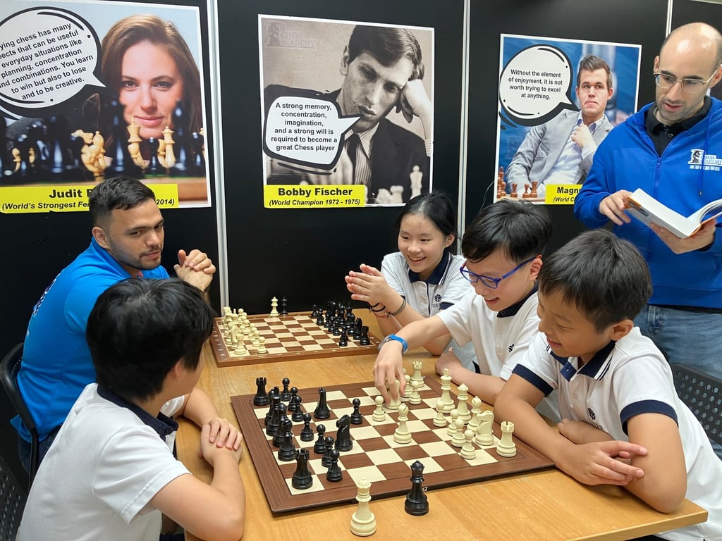 Brandon, Annabel, and teammates Maximus Pang and Chase Xuanfu Yau with their chess teachers. Photo: Handout