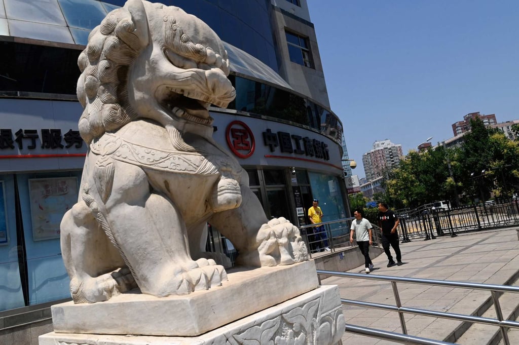 People walk past an ICBC bank branch in Beijing on June 15, 2023. Photo: AFP