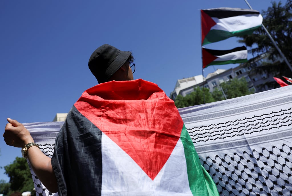 A demonstrator wears a Palestinian flag, as people call for a ceasefire in Gaza during a rally to commemorate Nakba Day, amid the ongoing conflict between Israel and the Palestinian Islamist group Hamas, in Madrid. Photo: Reuters