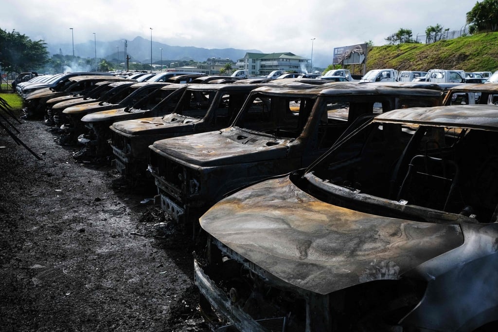 Burnt-out cars are seen outside a showroom in Noumea on Tuesday. Hundreds of cars were set alight overnight, as were more than 30 businesses, shops and factories. Photo: AFP Burnt-out cars are seen outside a showroom in Noumea on Tuesday. Hundreds of cars were set alight overnight, as were more than 30 businesses, shops and factories. Photo: AFP