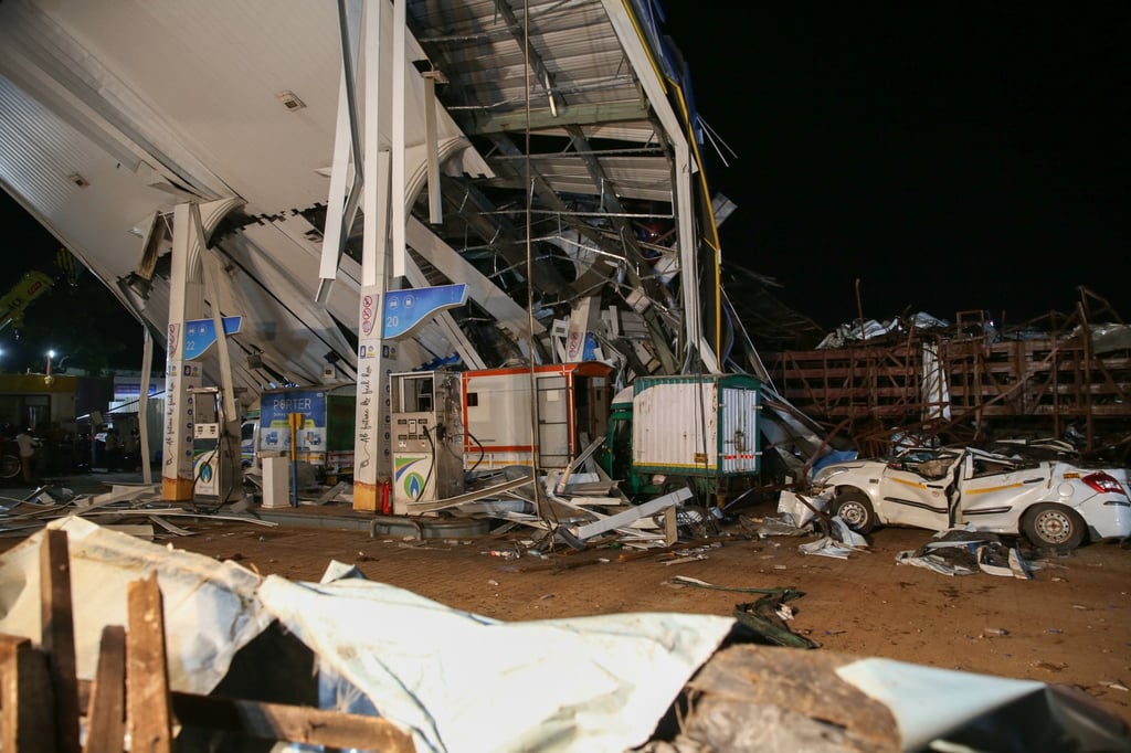 The damage at a petrol station in Mumbai on Monday after a giant advertising hoarding fell during a storm. Photo: EPA-EFE