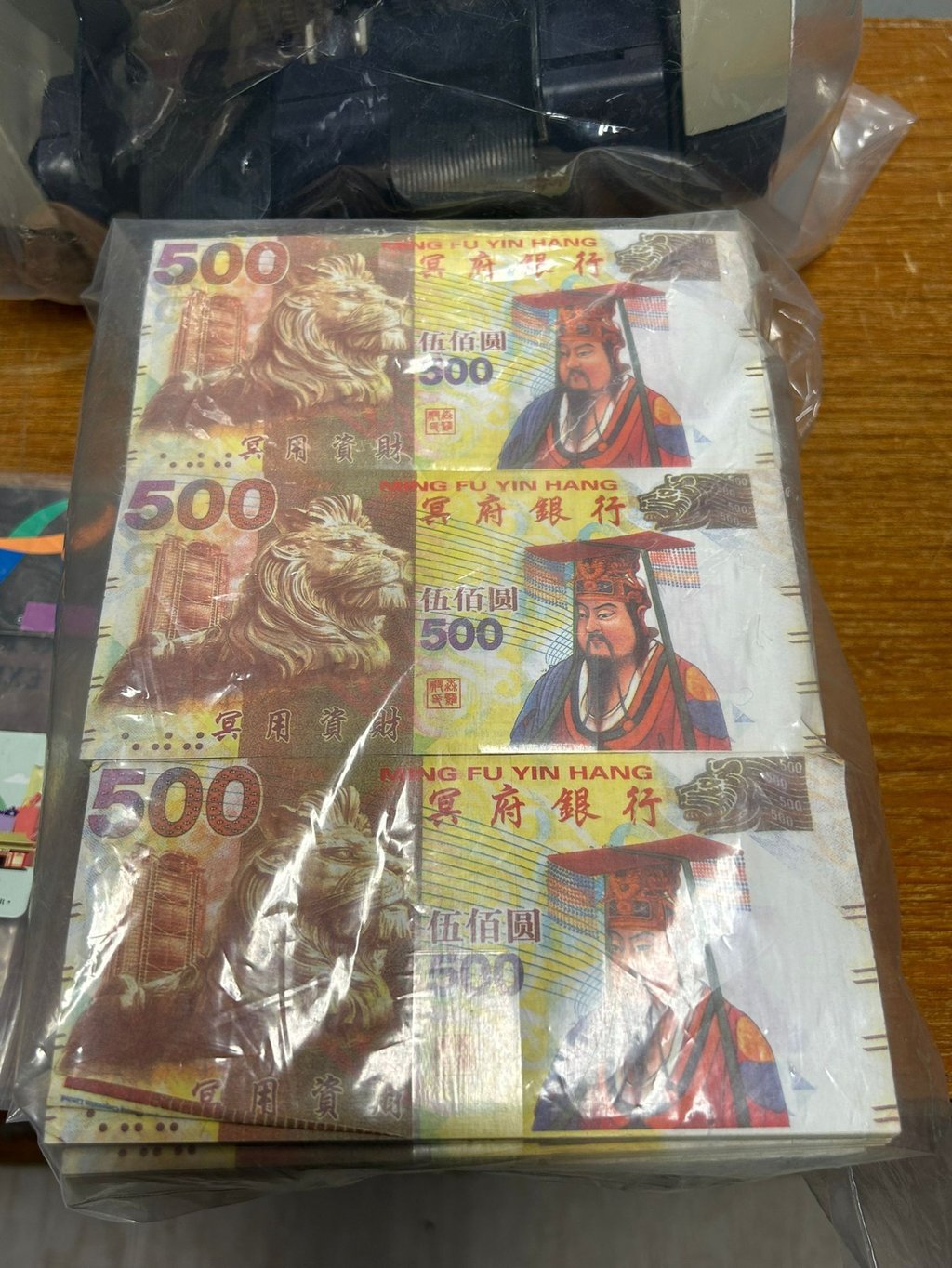 Police confiscated 3,000 hell banknotes with a face value of HK$500. Photo: Handout Police confiscated 3,000 hell banknotes with a face value of HK$500. Photo: Handout