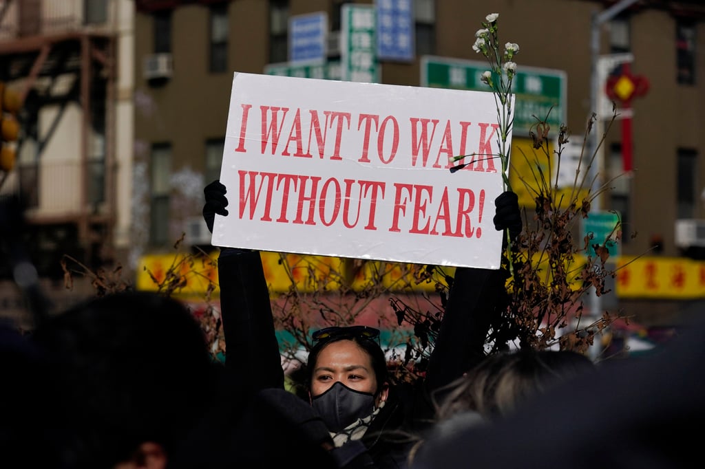 A sign is held aloft during a rally in New York on February 14, 2022, a day after the killing of Christina Yuna Lee in her Manhattan apartment building. Lee’s stabbing death sparked anger in the city’s Asian-American community. Photo: AP