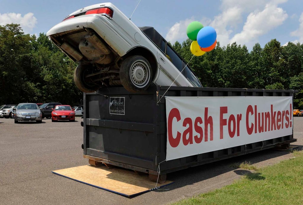 An old car dropped in an industrial trash bin advertising the Cash for Clunkers programme in Culpeper, Virginia, on August 1, 2009. Americans flocked to auto dealerships to take advantage of government rebates for petrol-guzzling “clunkers” and promptly drained the programme’s US$1 billion in funding. Photo: Reuters An old car dropped in an industrial trash bin advertising the Cash for Clunkers programme in Culpeper, Virginia, on August 1, 2009. Americans flocked to auto dealerships to take advantage of government rebates for petrol-guzzling “clunkers” and promptly drained the programme’s US$1 billion in funding. Photo: Reuters