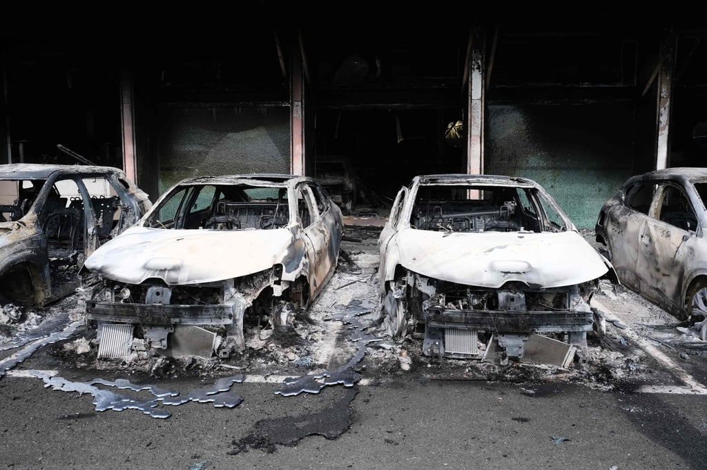 Burnt cars are pictured at a car dealer store in the Magenta district in Noumea on Tuesday. Photo: AFP Burnt cars are pictured at a car dealer store in the Magenta district in Noumea on Tuesday. Photo: AFP