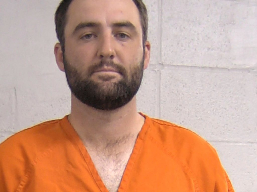 Scheffler was booked with a mugshot taken in an orange jumpsuit before being released. Photo: AP Scheffler was booked with a mugshot taken in an orange jumpsuit before being released. Photo: AP