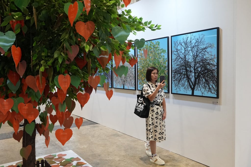 A visitor takes pictures of Season’s Change by Ewan David Eason at the Affordable Art Fair 2024 at the Hong Kong Convention and Exhibition Centre. Photo: Elson Li