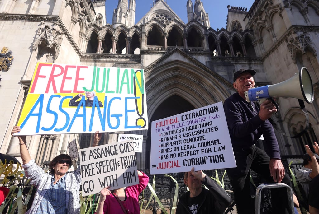 Supporters hold placards outside the High Court during WikiLeaks’ founder Julian Assange’s extradition appeal hearing in London on Monday. Photo: EPA-EFE Supporters hold placards outside the High Court during WikiLeaks’ founder Julian Assange’s extradition appeal hearing in London on Monday. Photo: EPA-EFE
