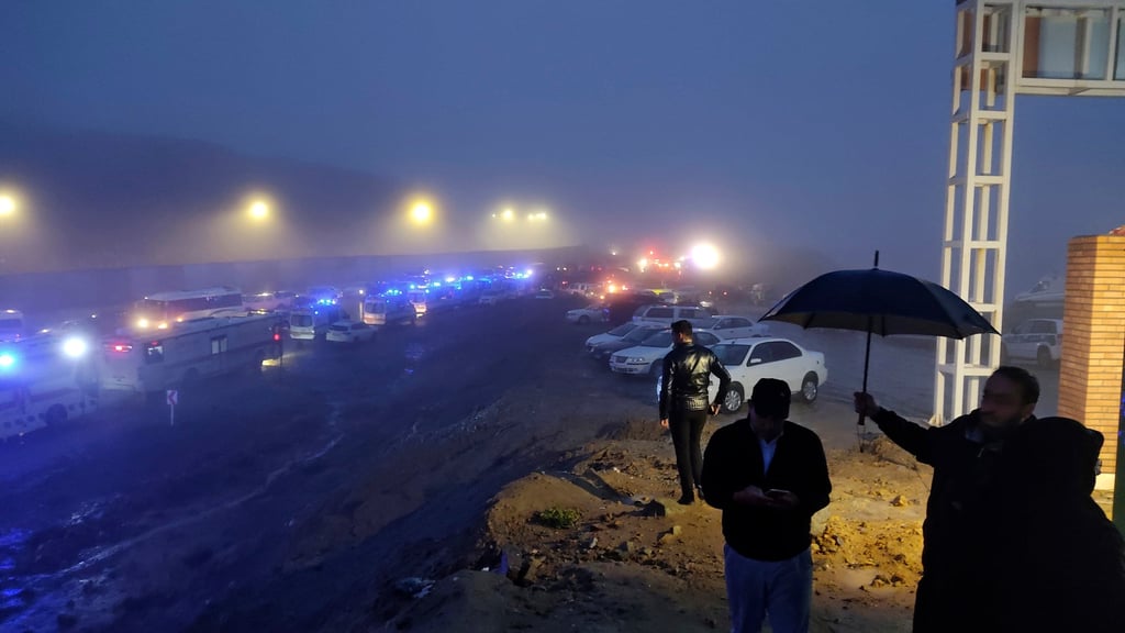 Rescue teams’ vehicles near the site of the helicopter incident. Photo: Moj News Agency via AP