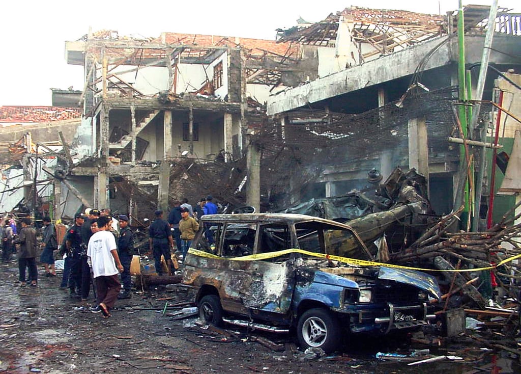 Police officers inspect the ruins of a nightclub in Denpasar destroyed in the Bali bombings of 2002. More than 200 people were killed in the attacks. Photo: AP Police officers inspect the ruins of a nightclub in Denpasar destroyed in the Bali bombings of 2002. More than 200 people were killed in the attacks. Photo: AP