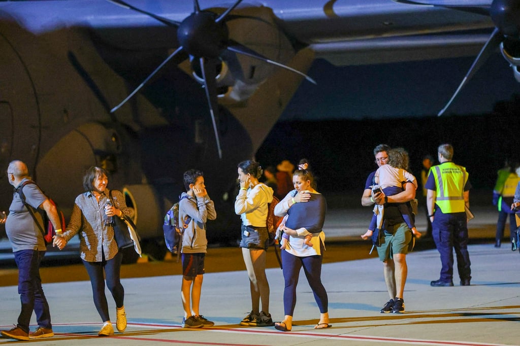 Repatriated Australian travellers arrive from New Caledonia to Brisbane International Airport, in Brisbane, Australia, on Tuesday. Photo: AAP via AP Repatriated Australian travellers arrive from New Caledonia to Brisbane International Airport, in Brisbane, Australia, on Tuesday. Photo: AAP via AP