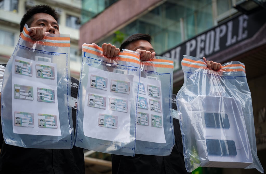 Immigration officers seized fake Hong Kong identity cards from the arrestees. Photo: Eugene Lee Immigration officers seized fake Hong Kong identity cards from the arrestees. Photo: Eugene Lee