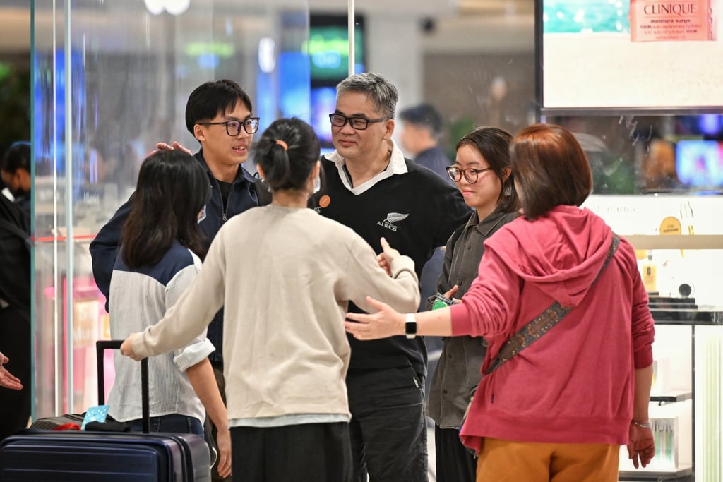 Passengers of Singapore Airlines flight SQ321, which made an emergency landing in Bangkok on its flight from London to Singapore, greet family members upon arrival at Changi Airport in Singapore on Wednesday. Photo: EPA-EFE
