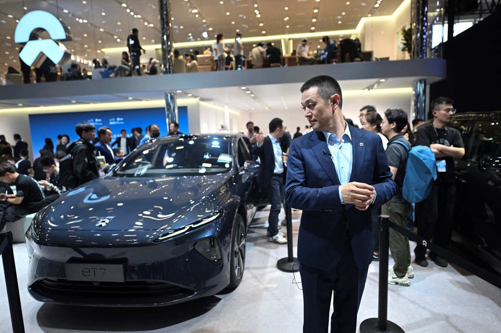 CEO William Li stands next to its ET7 model on display at the Beijing Auto Show on April 25, 2024. Photo: AFP