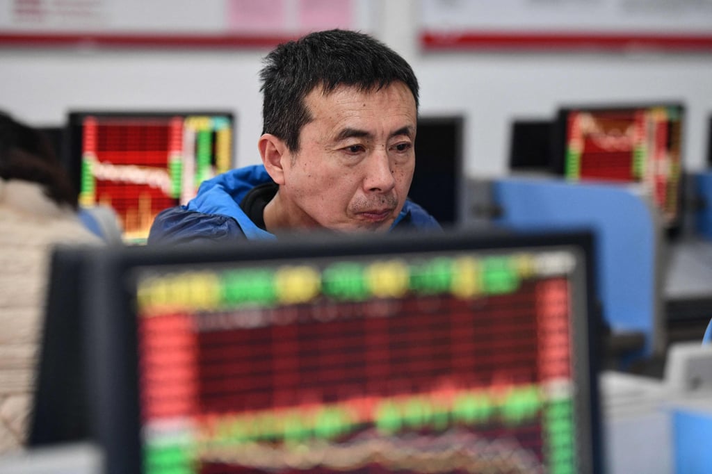 An investor looks at screens showing stock market movements at a securities company in Fuyang in China’s eastern Anhui province on January 17, 2024. Photo: AFP