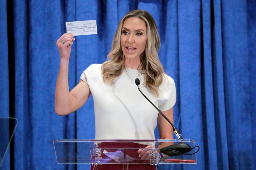 Lara Trump, the newly elected co-chair of the Republican National Committee, holds up a donation check as she gives an address in Houston, Texas, in March. Photo: AP Lara Trump, the newly elected co-chair of the Republican National Committee, holds up a donation check as she gives an address in Houston, Texas, in March. Photo: AP