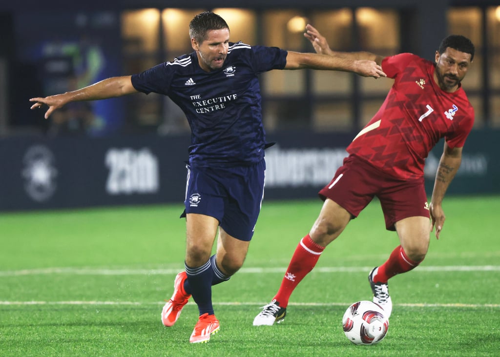 Allan Fraser of HKFC Chairman’s Select (left) vies with PFA All Stars’ Hayden Mullins. Photo: Jonathan Wong