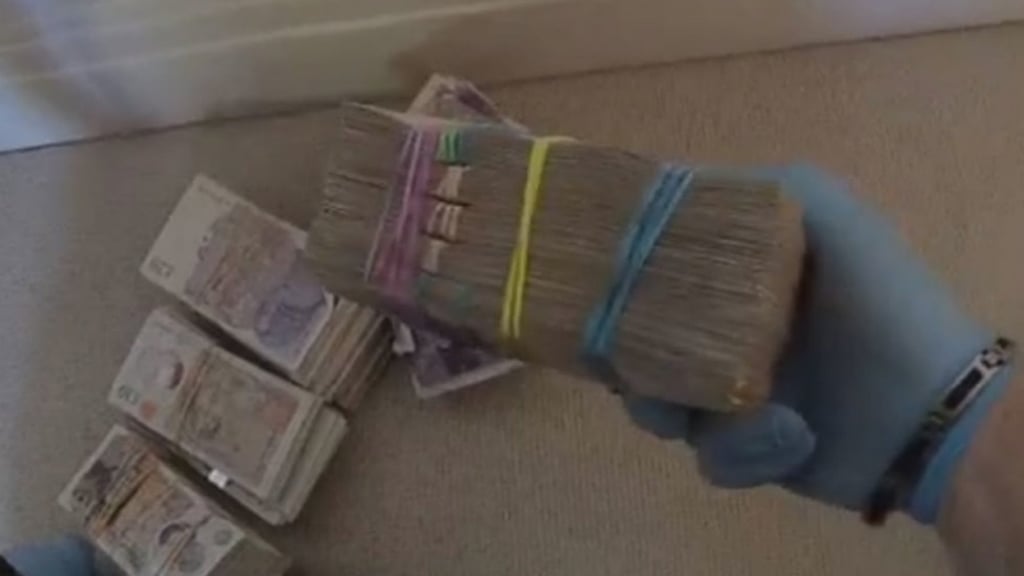 Piles of cash discovered during police searches connected to Wen Jian. Piles of cash discovered during police searches connected to Wen Jian.